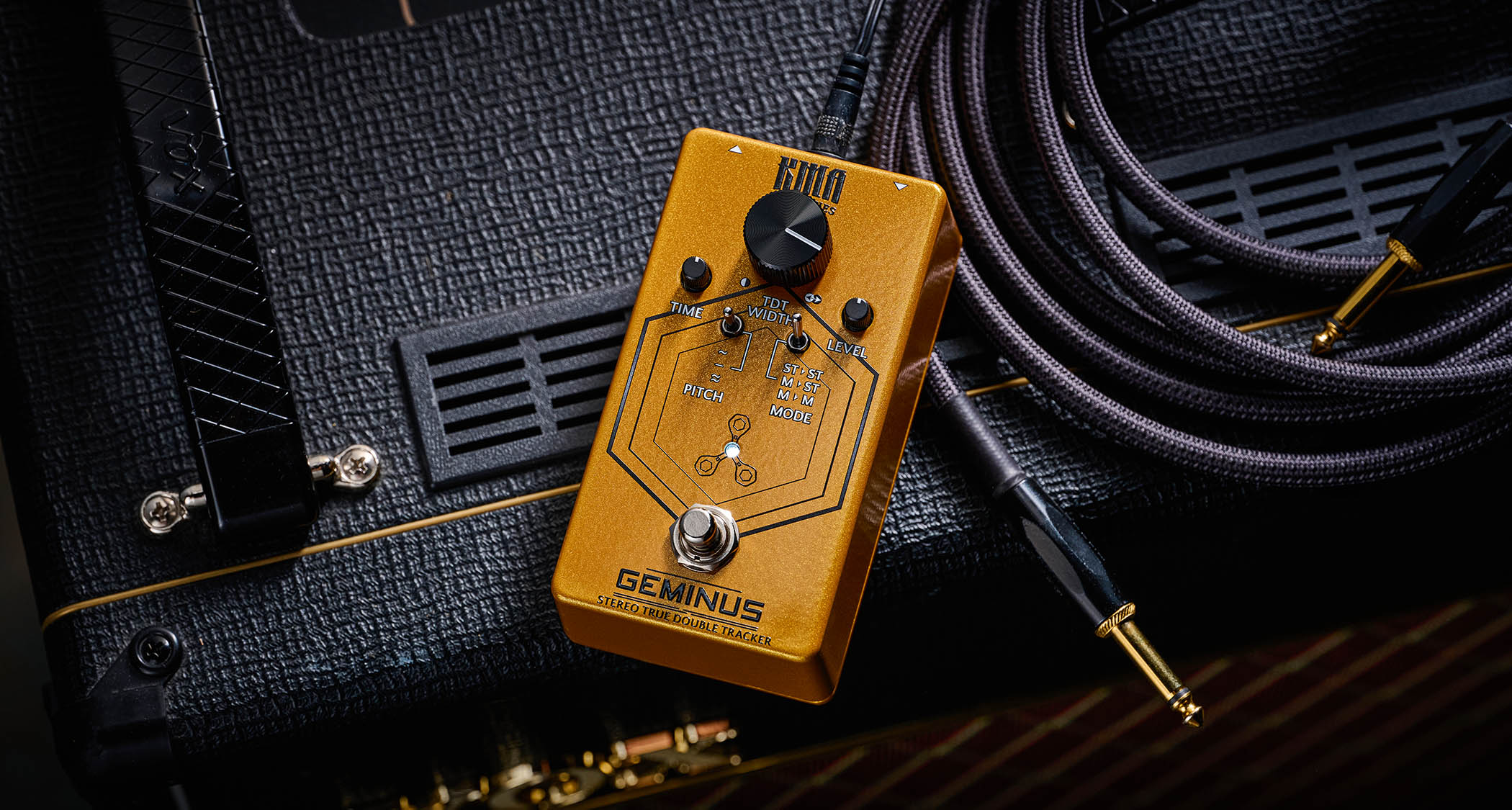 KMA Geminus Stereo True Double Tracker: the gold stompbox's fascia is dominated by one large black dial and is photographed here in close-up.