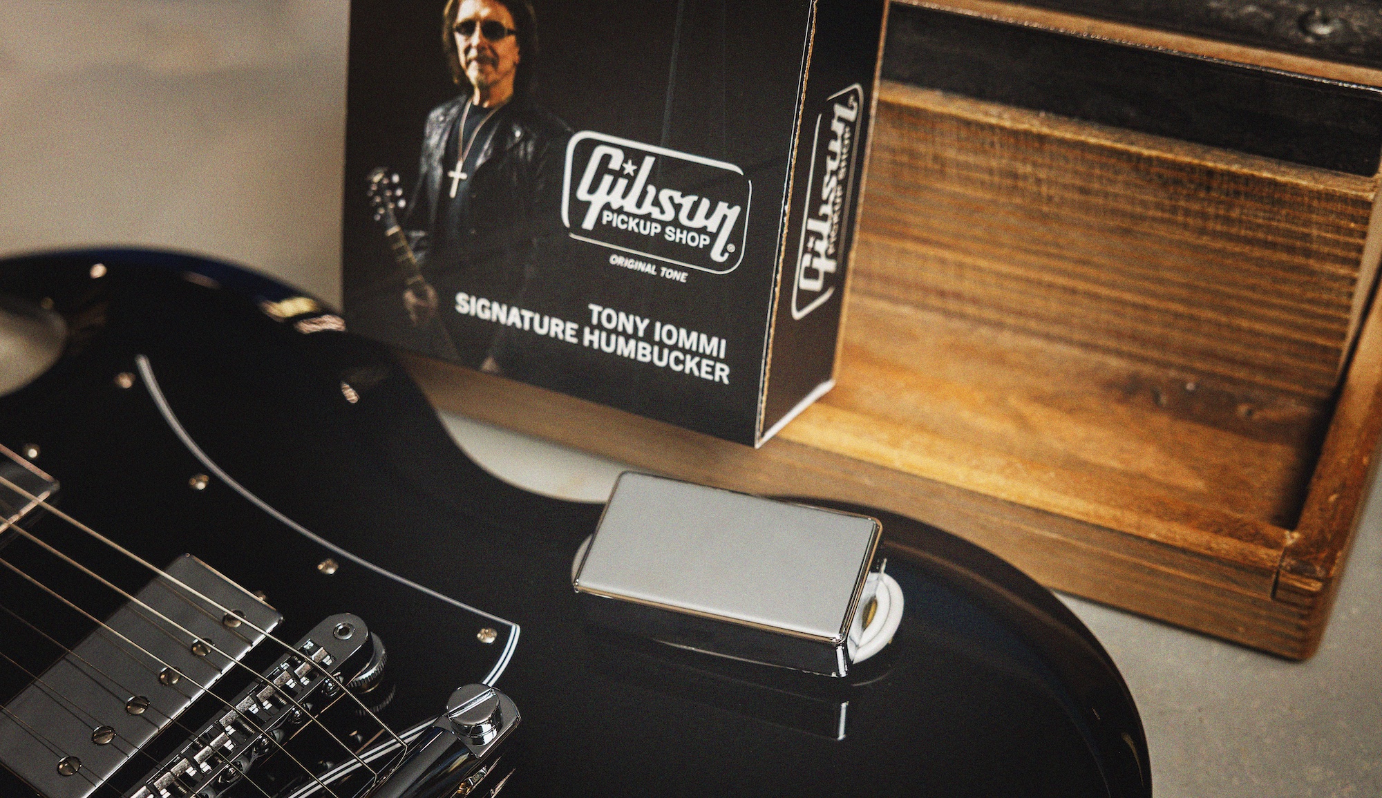 A Gibson Tony Iommi Humbucker sits atop a black Gibson SG guitar 