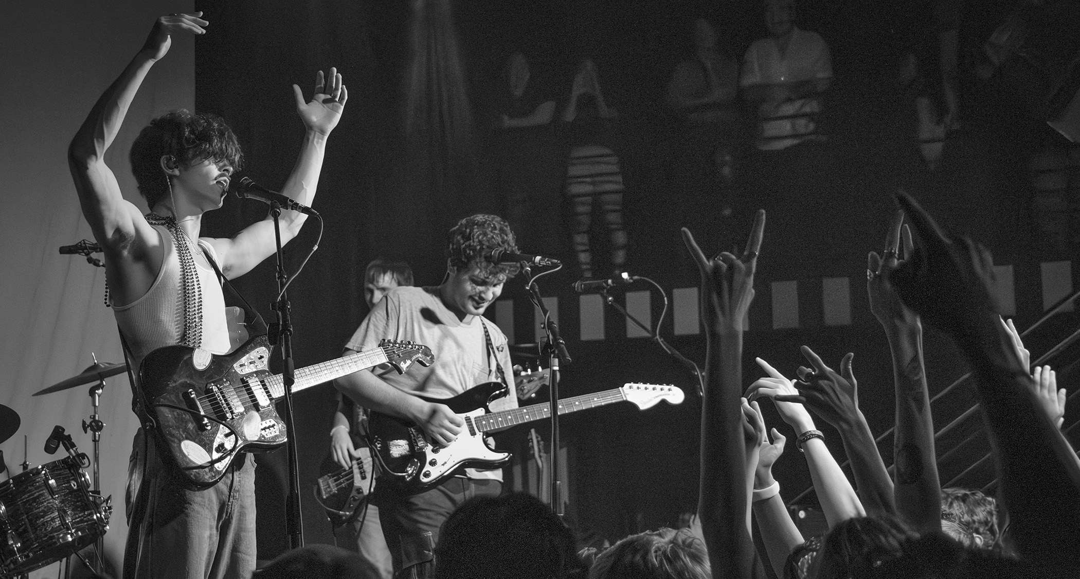 A black-and-white live shot of Phoneboy's Ricky Dana [left] and Wyn Barnum in front of a fired-up crowd.