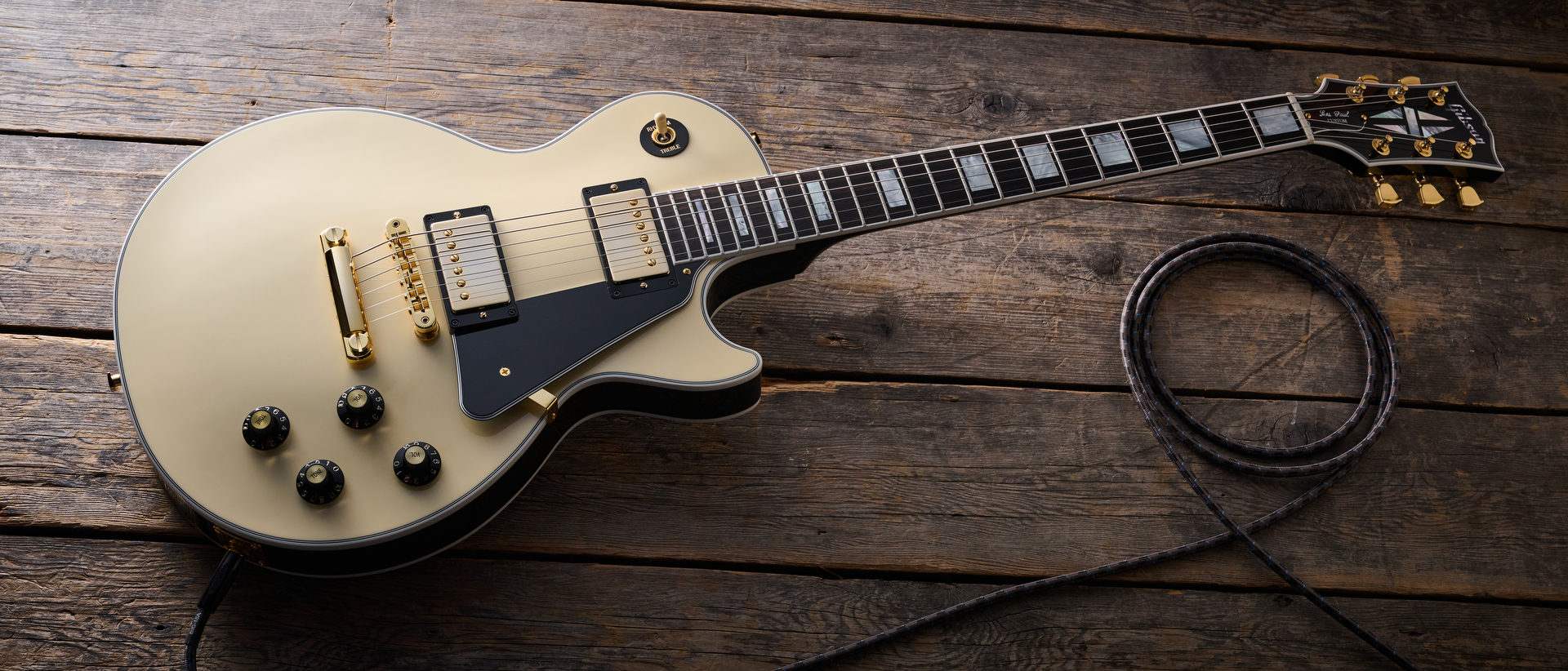 Gibson Les Paul Custom 70s in Buttercream (off-white) finish with gold hardware, block inlays and split-diamond headstock