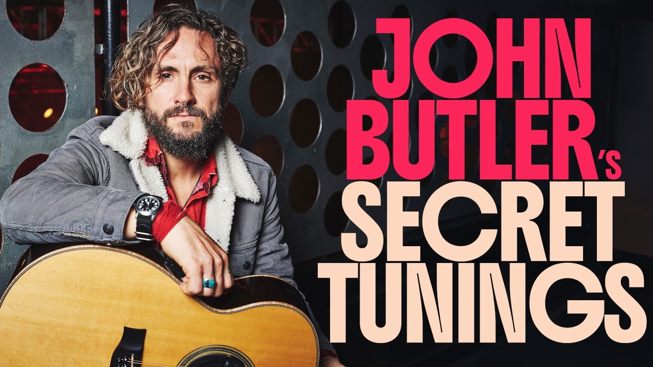 John Butler poses with an acoustic guitar